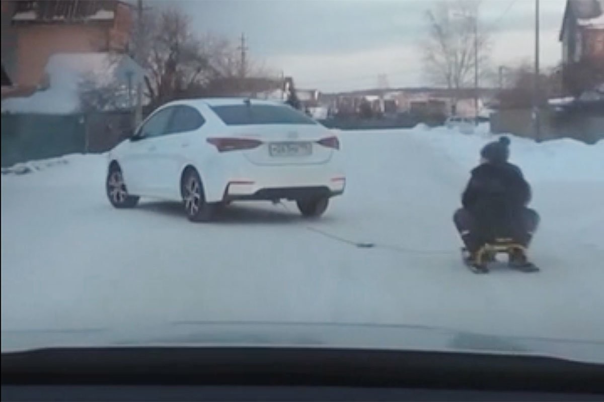 Отец решил прокатить детей с ветерком и привязал снегокат к автомобилю